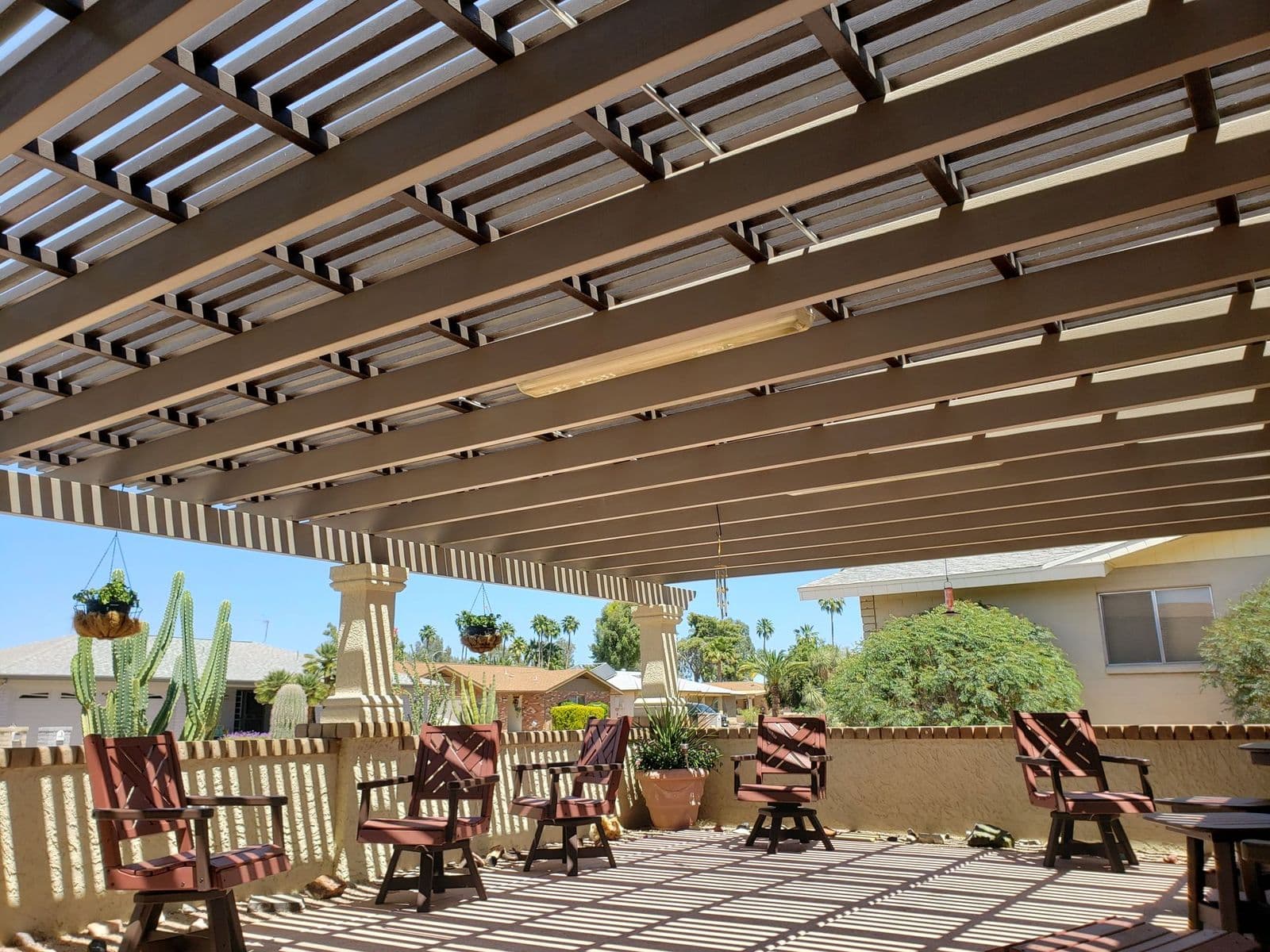 Lattice patio cover over a backyard seating area