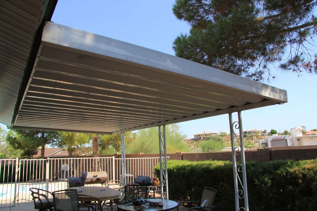 Solid aluminum patio cover beside a backyard pool