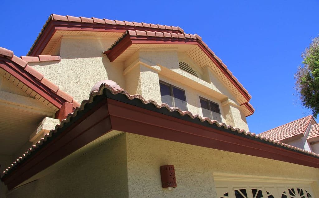 Two-story home with a red tile roof and matching fascia